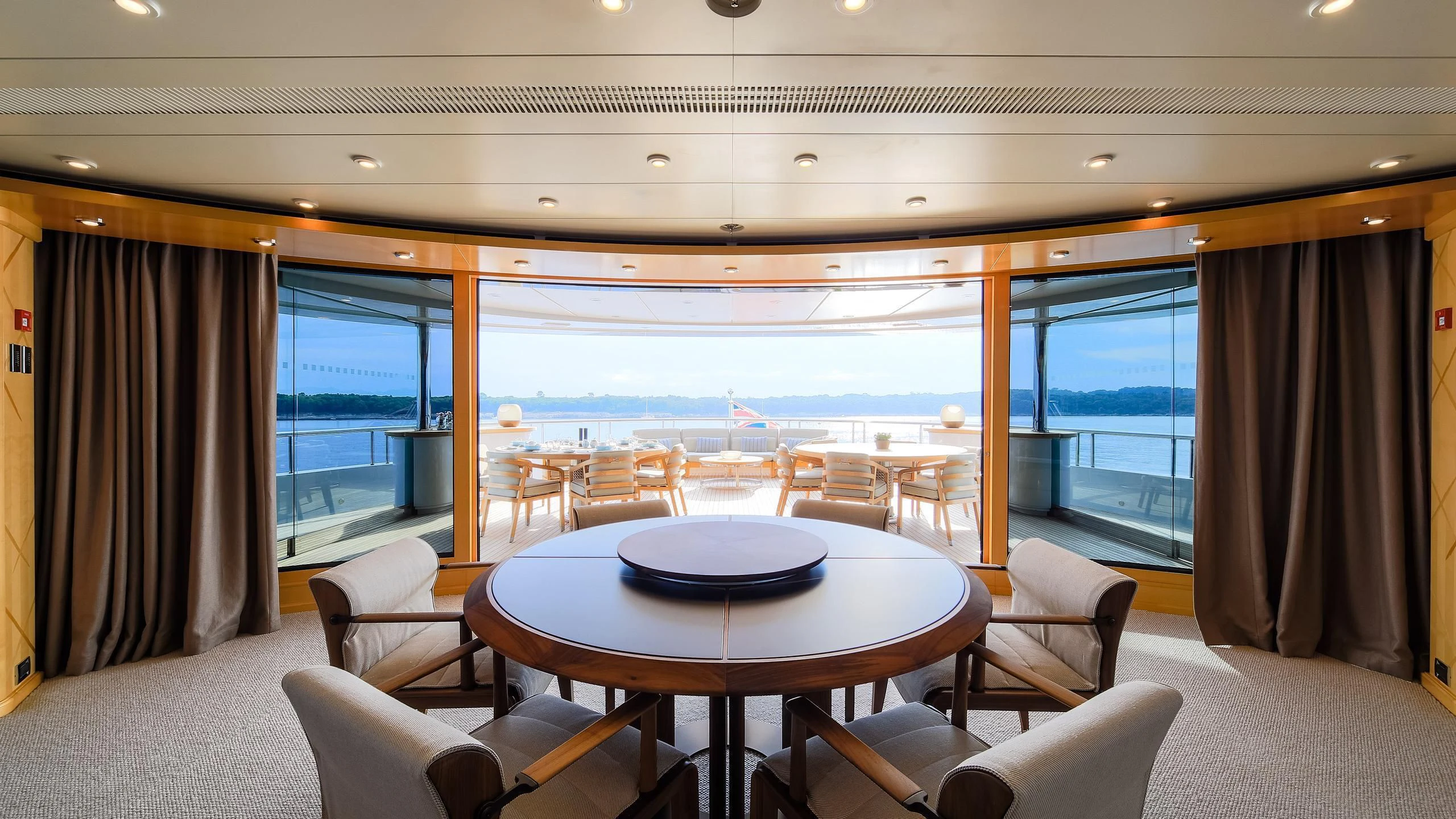 a room with a table and chairs aboard AHS Yacht for Sale