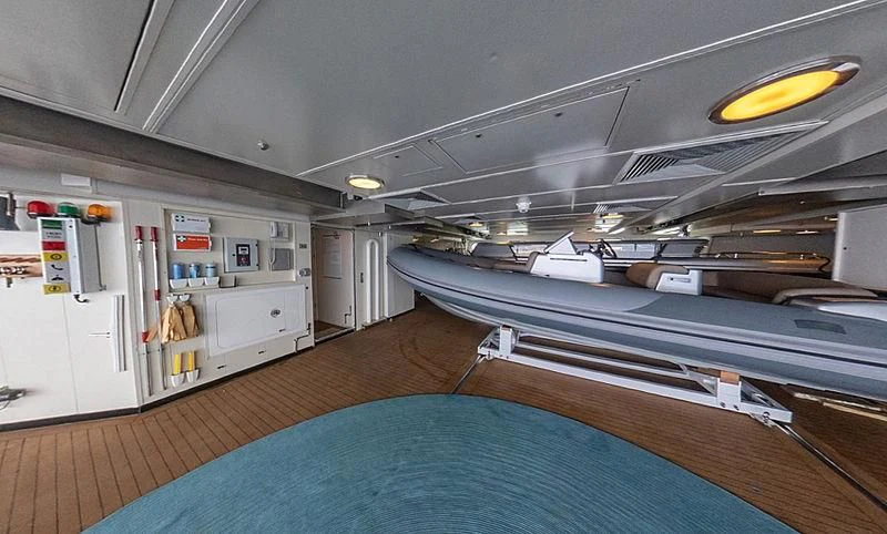 a room with a bed and a desk aboard AHS Yacht for Sale
