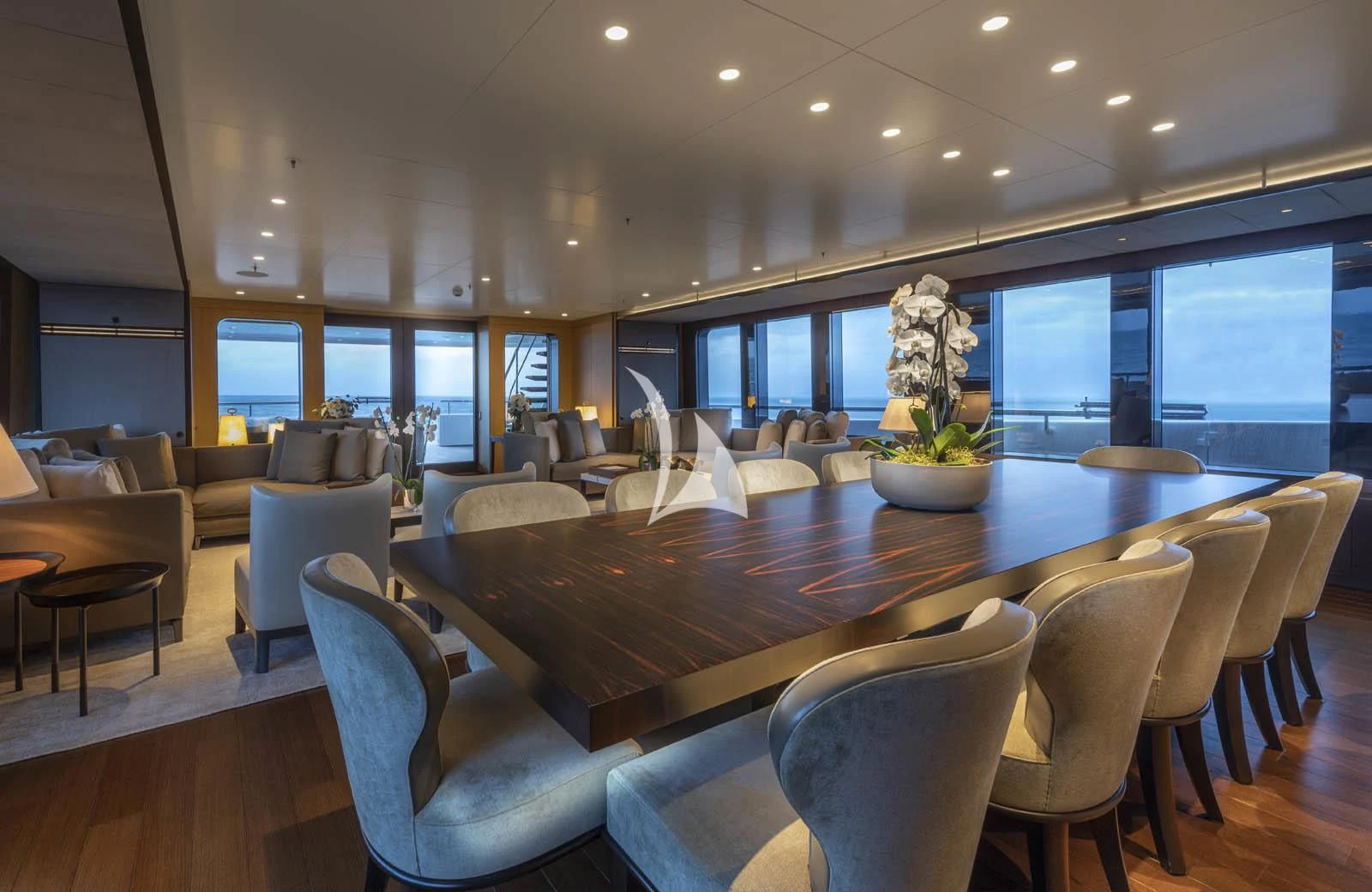 a large room with a table and chairs aboard HALO Yacht for Charter