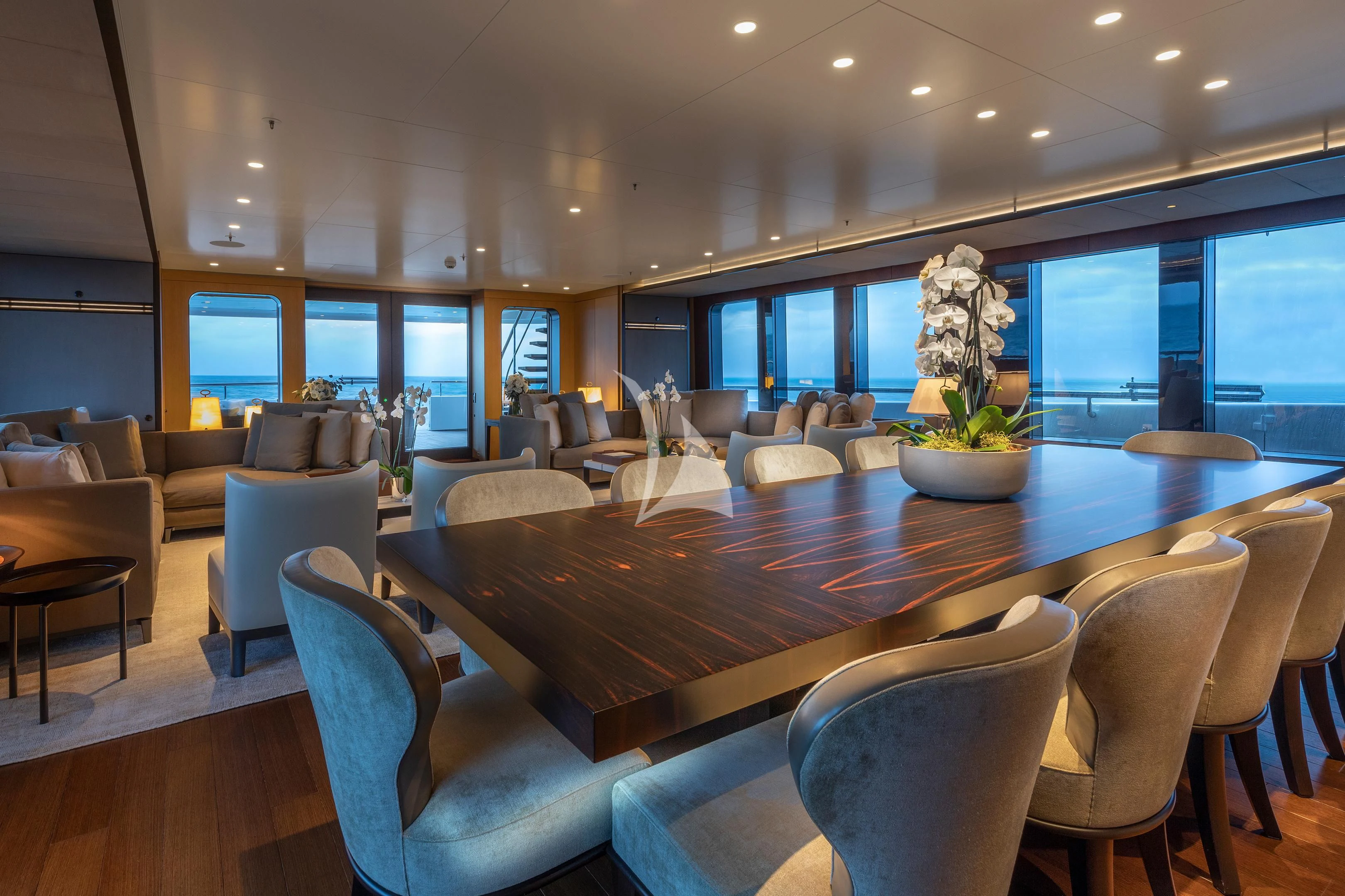 a large dining table in a room aboard HALO Yacht for Charter