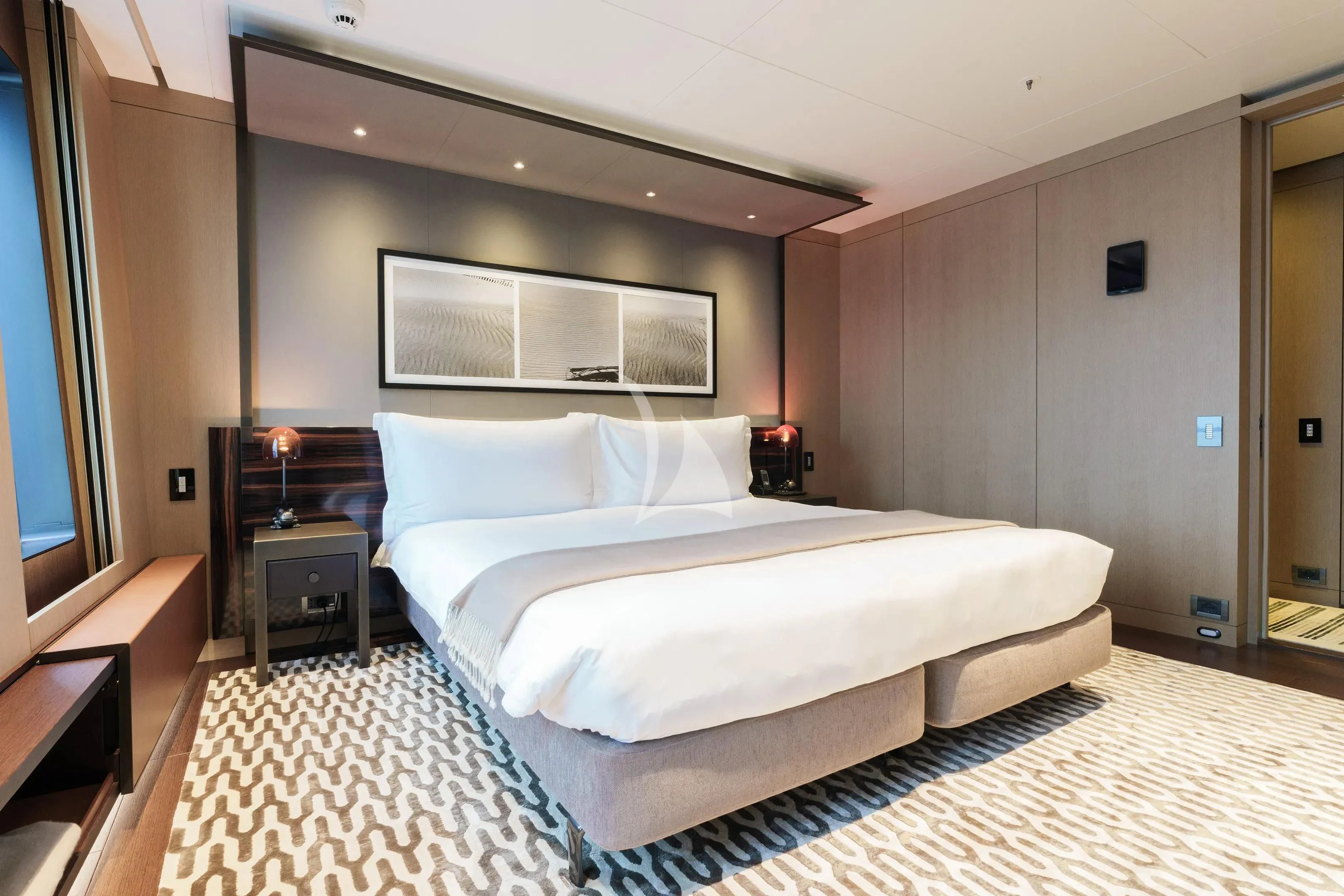 a large bedroom with a large bed aboard HALO Yacht for Charter