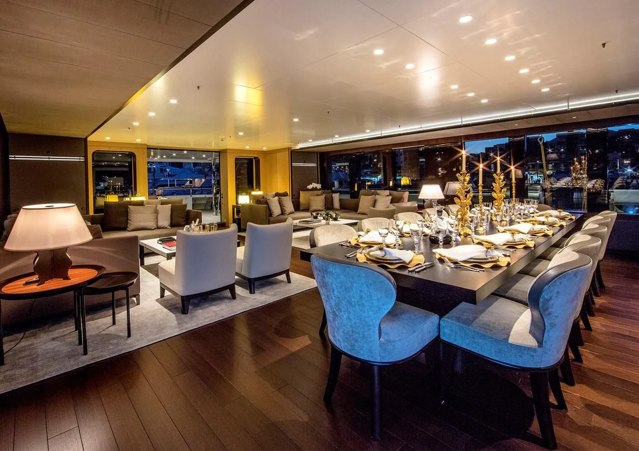 a large room with a table and chairs aboard HALO Yacht for Charter