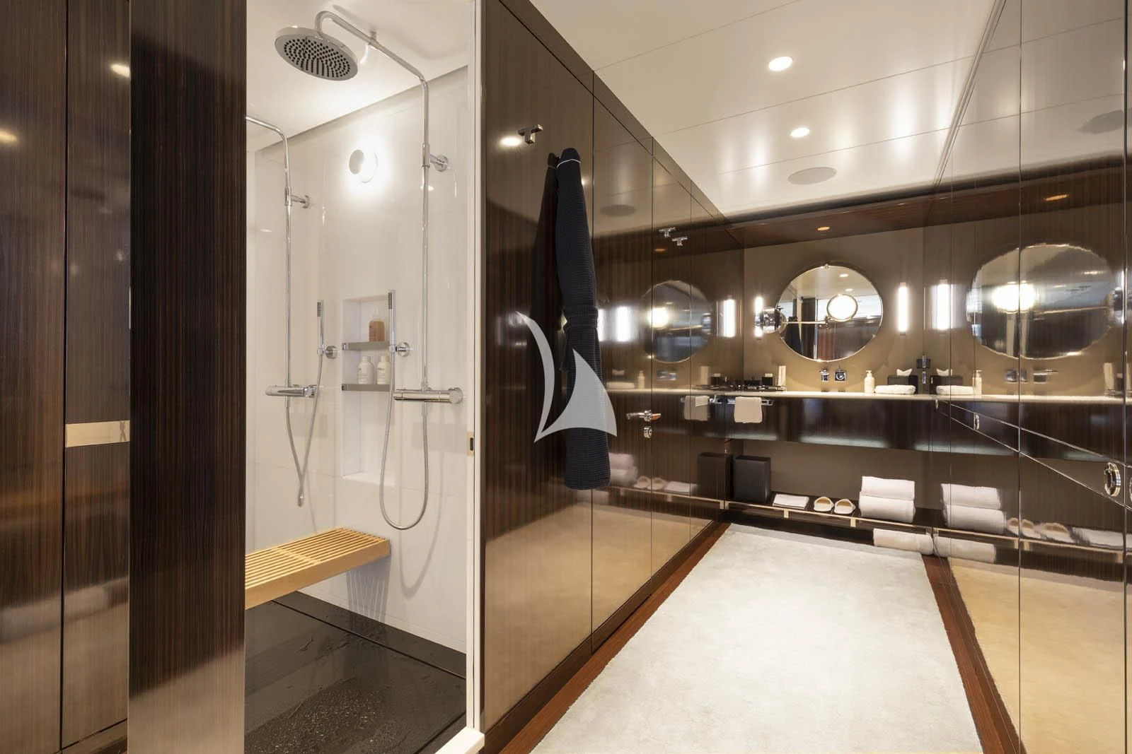 a large bathroom with a large mirror aboard HALO Yacht for Charter