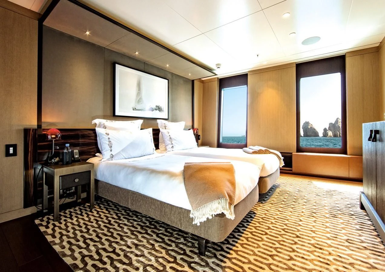 a large bedroom with a large bed aboard HALO Yacht for Charter