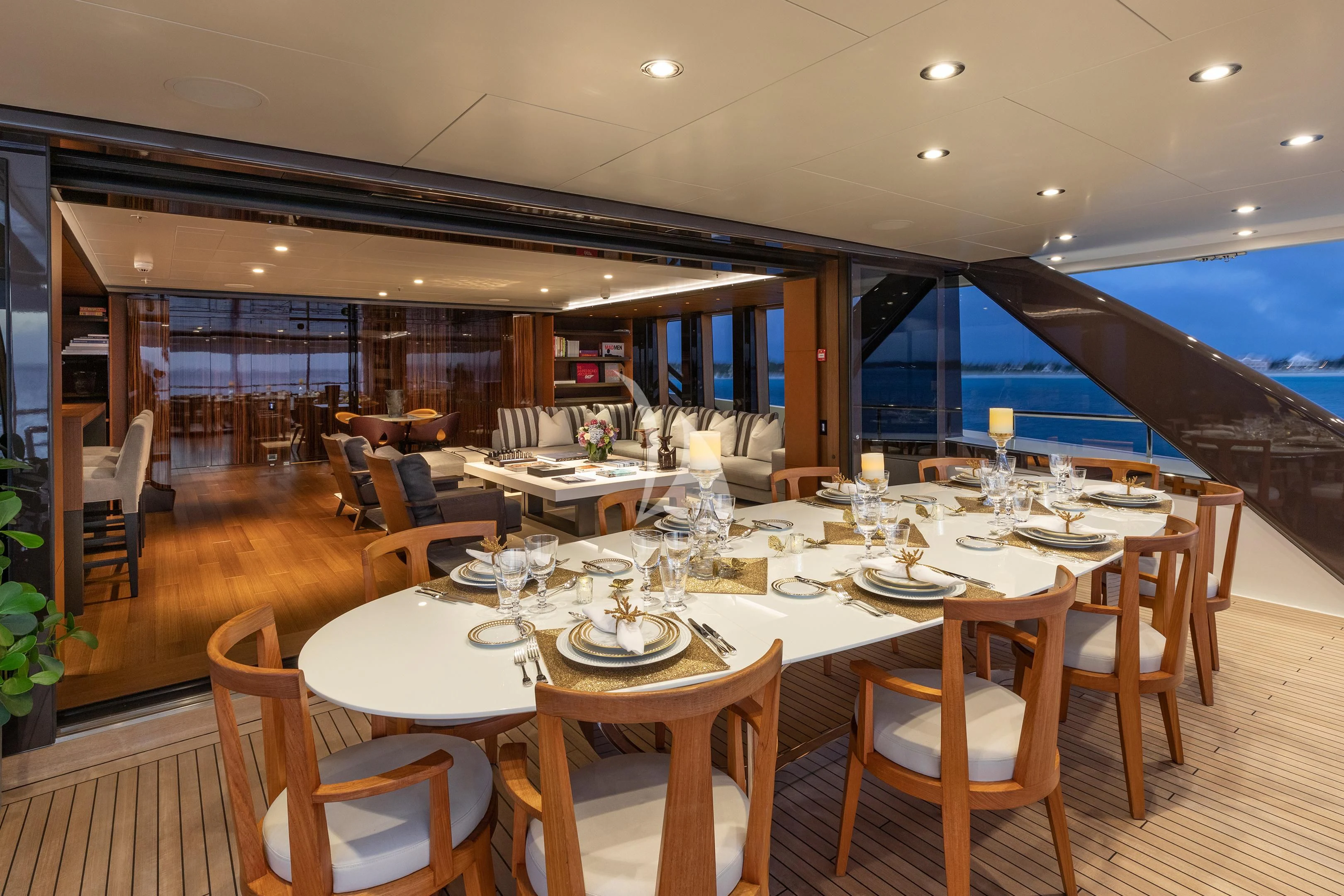 a dining room with a table set for a dinner aboard HALO Yacht for Charter