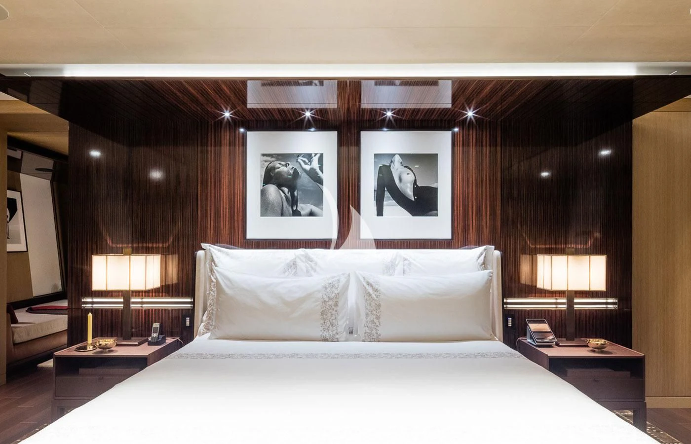 a bed with white sheets aboard HALO Yacht for Charter