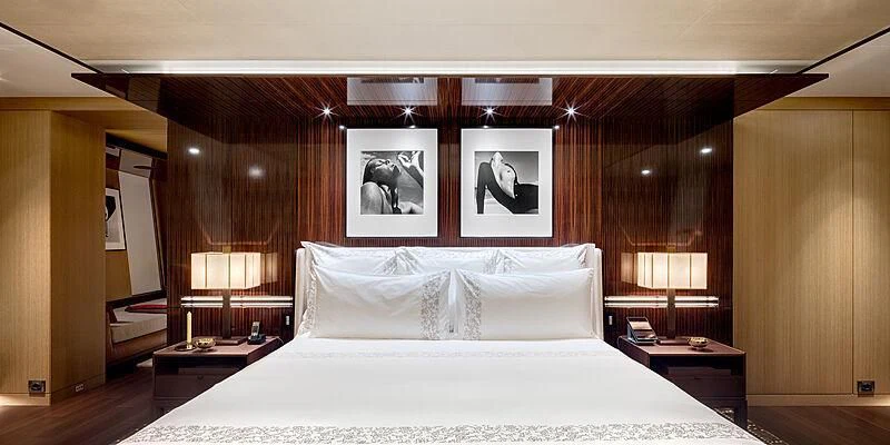a bed with a white sheet and pillows aboard HALO Yacht for Charter