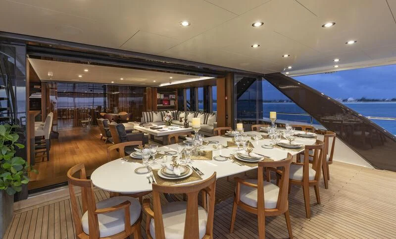 a dining room with a large table and chairs aboard HALO Yacht for Charter