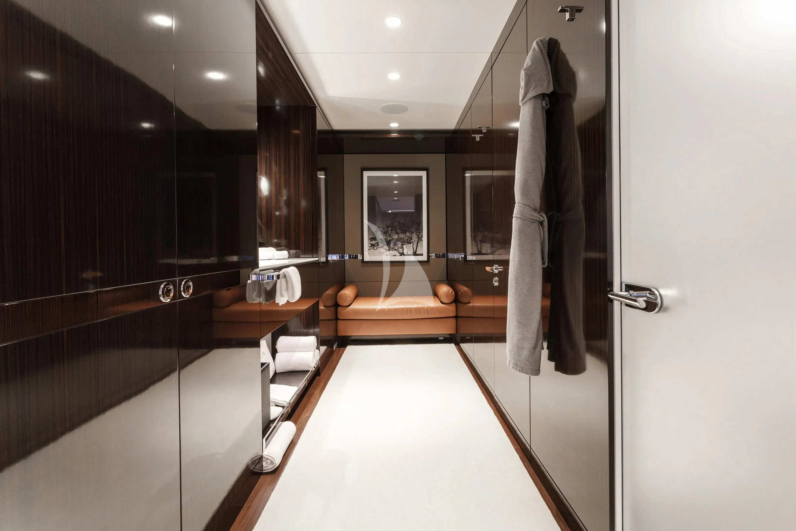 a room with a large mirror and a table with chairs aboard HALO Yacht for Charter