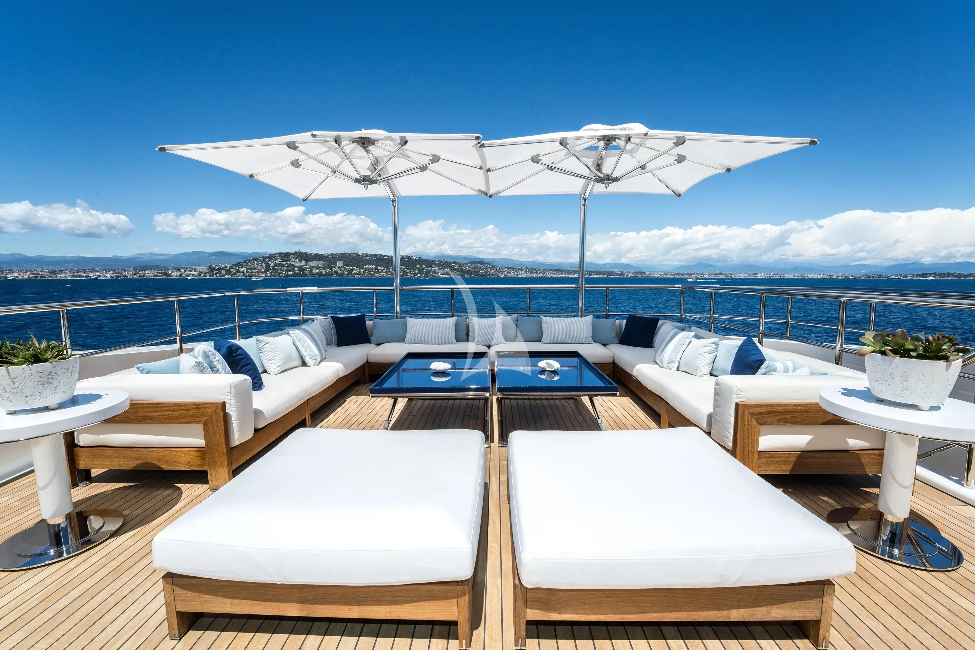 a patio with a large white umbrella aboard HALO Yacht for Charter