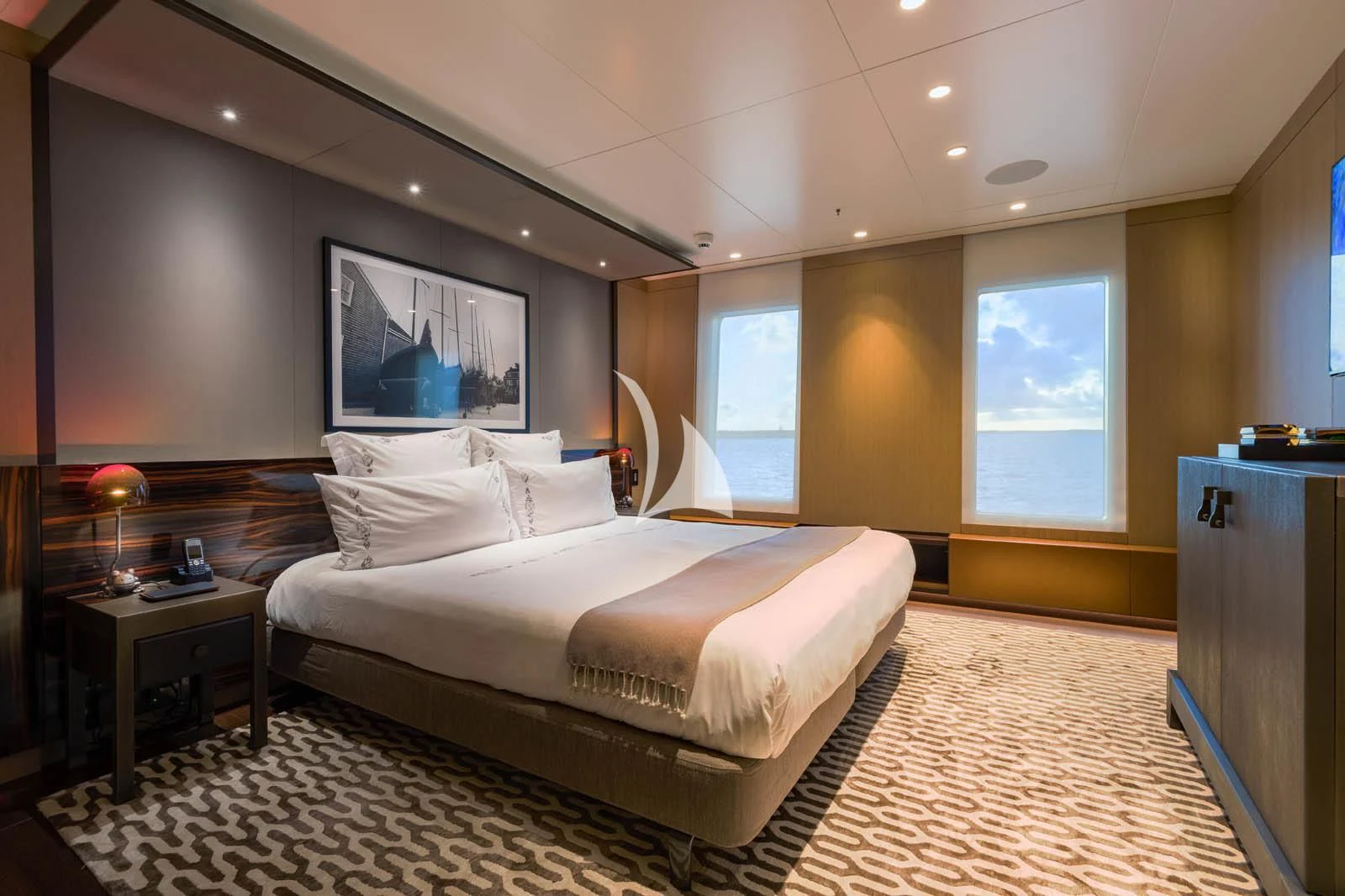 a large bedroom with a large bed aboard HALO Yacht for Charter