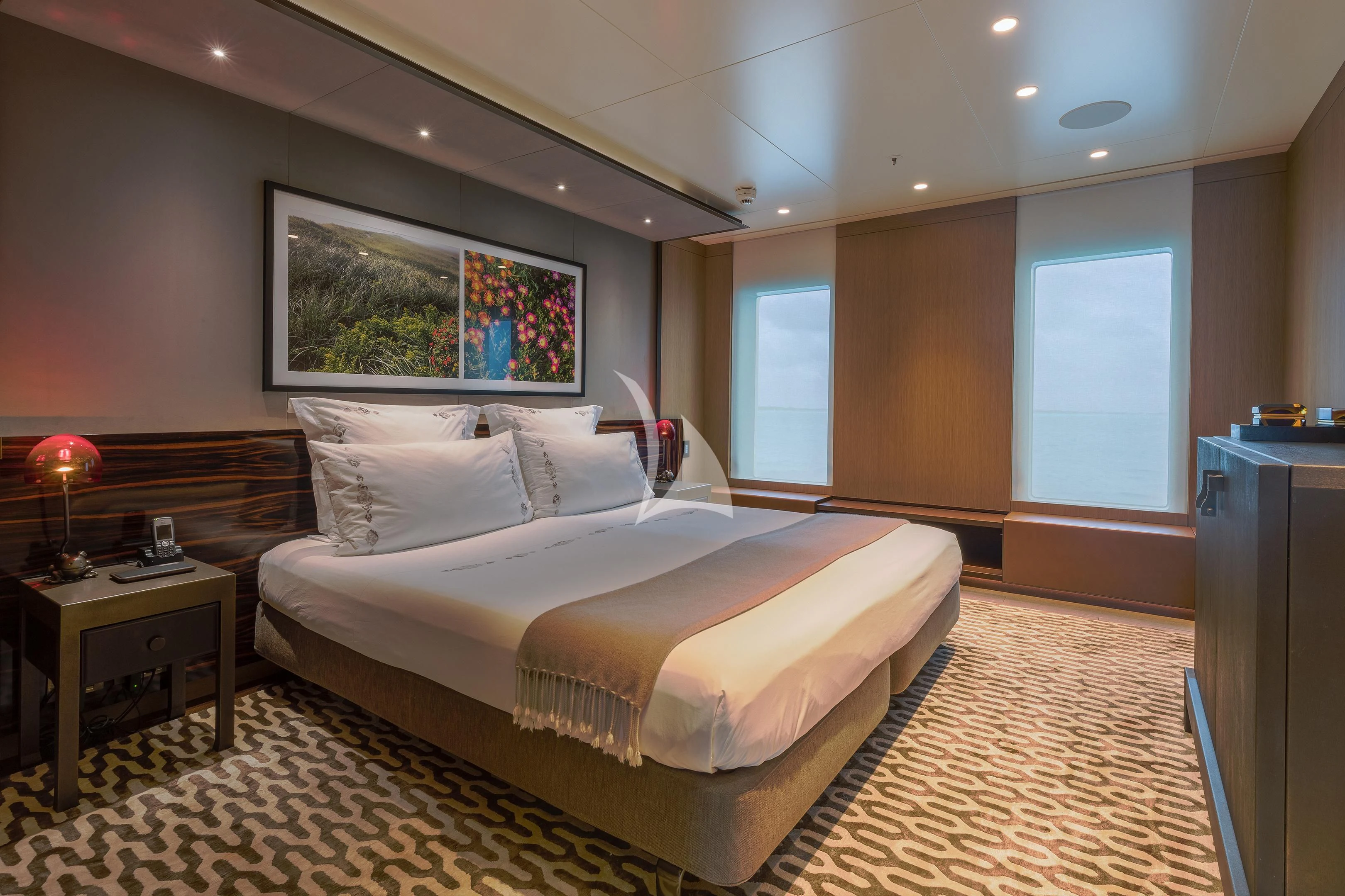 a large bedroom with a large bed aboard HALO Yacht for Charter