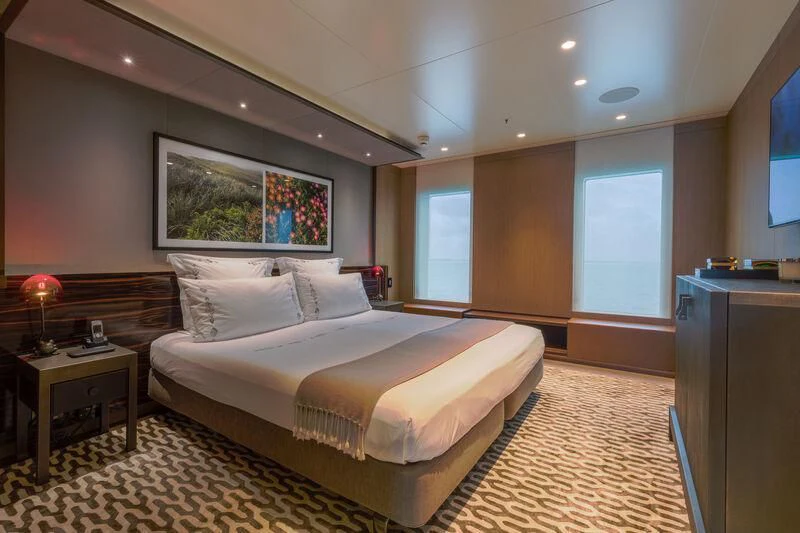 a large bedroom with a large bed aboard HALO Yacht for Charter
