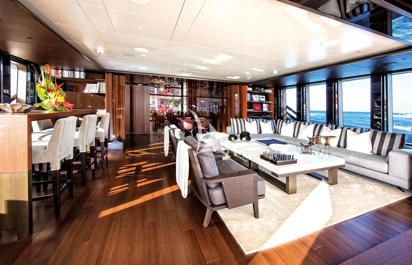 a room with a couch and a table and chairs aboard HALO Yacht for Charter