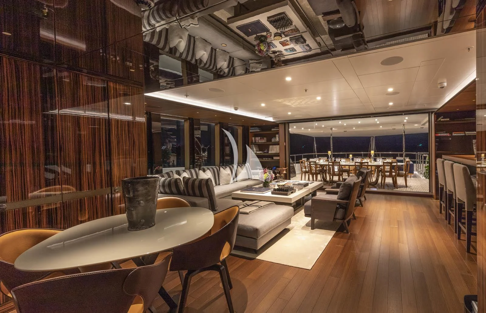 a room with a table chairs and a large window aboard HALO Yacht for Charter