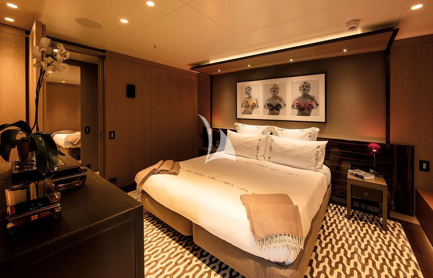 a large bedroom with a large bed aboard HALO Yacht for Charter