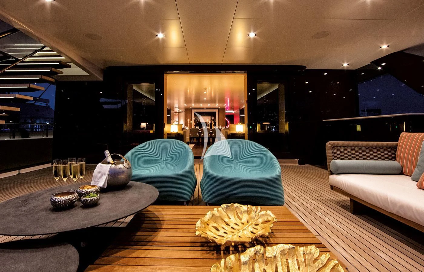a large living room with a large table and chairs aboard HALO Yacht for Charter