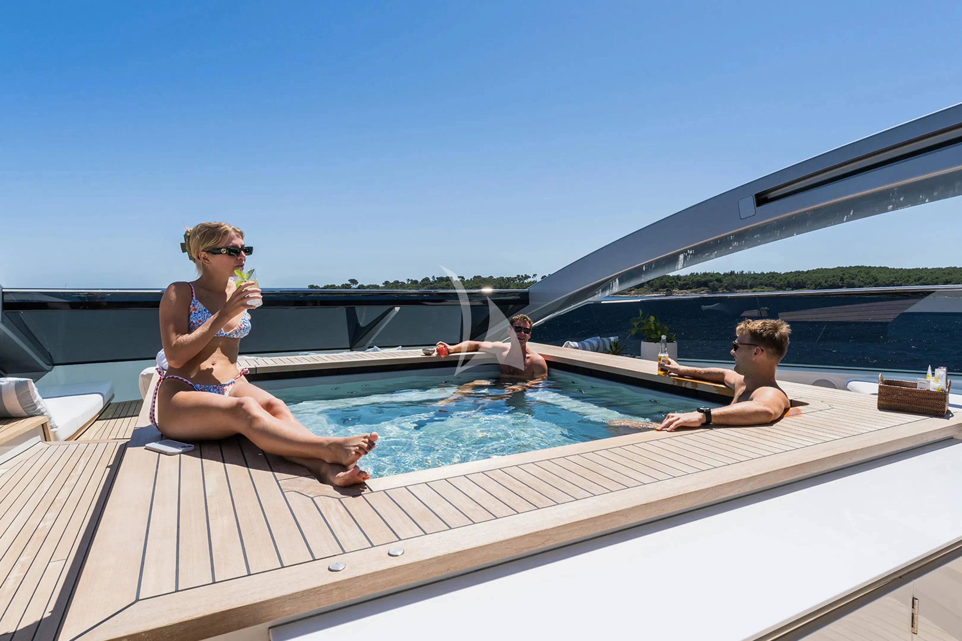a group of people sitting in a pool aboard HALO Yacht for Charter