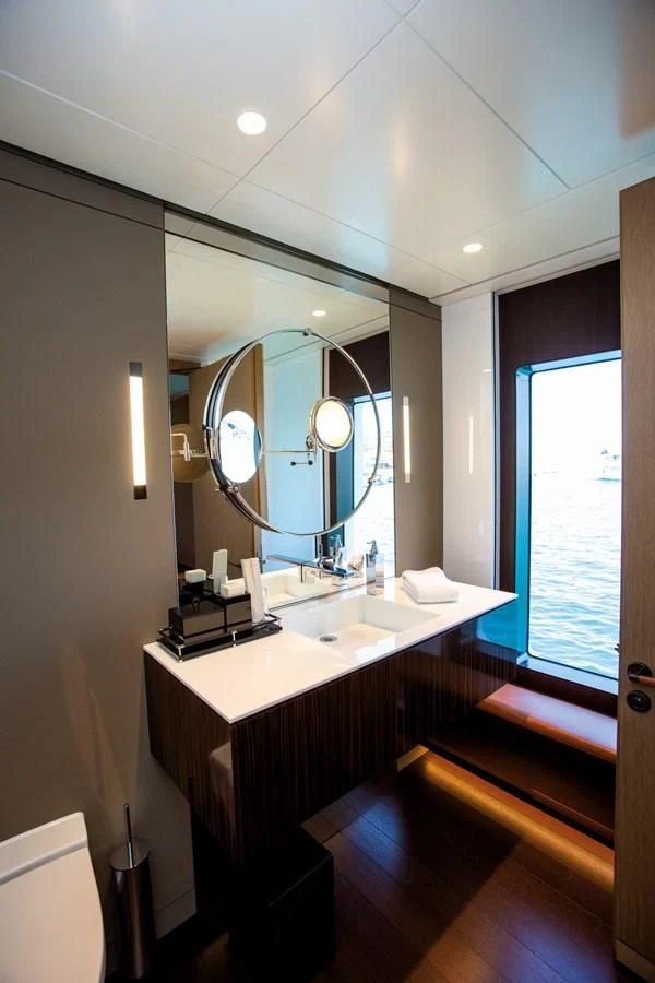 a bathroom with a large mirror aboard HALO Yacht for Charter