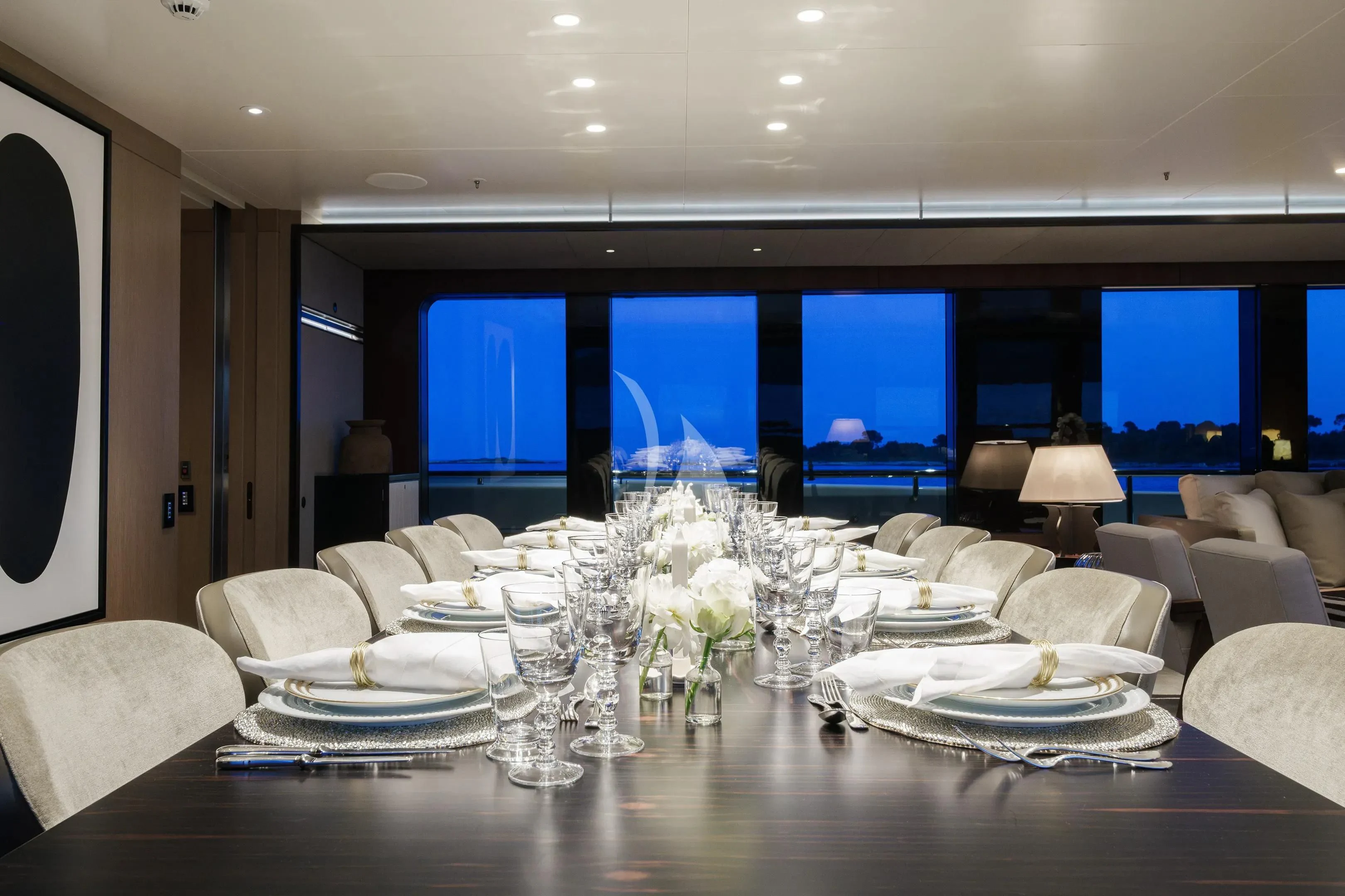a large room with a table and chairs aboard HALO Yacht for Charter