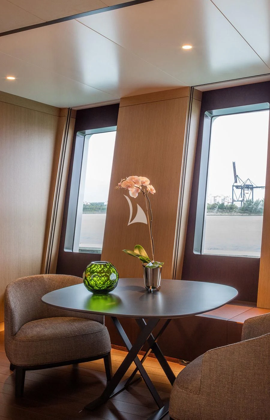 a table with a plant in a vase on it aboard HALO Yacht for Charter