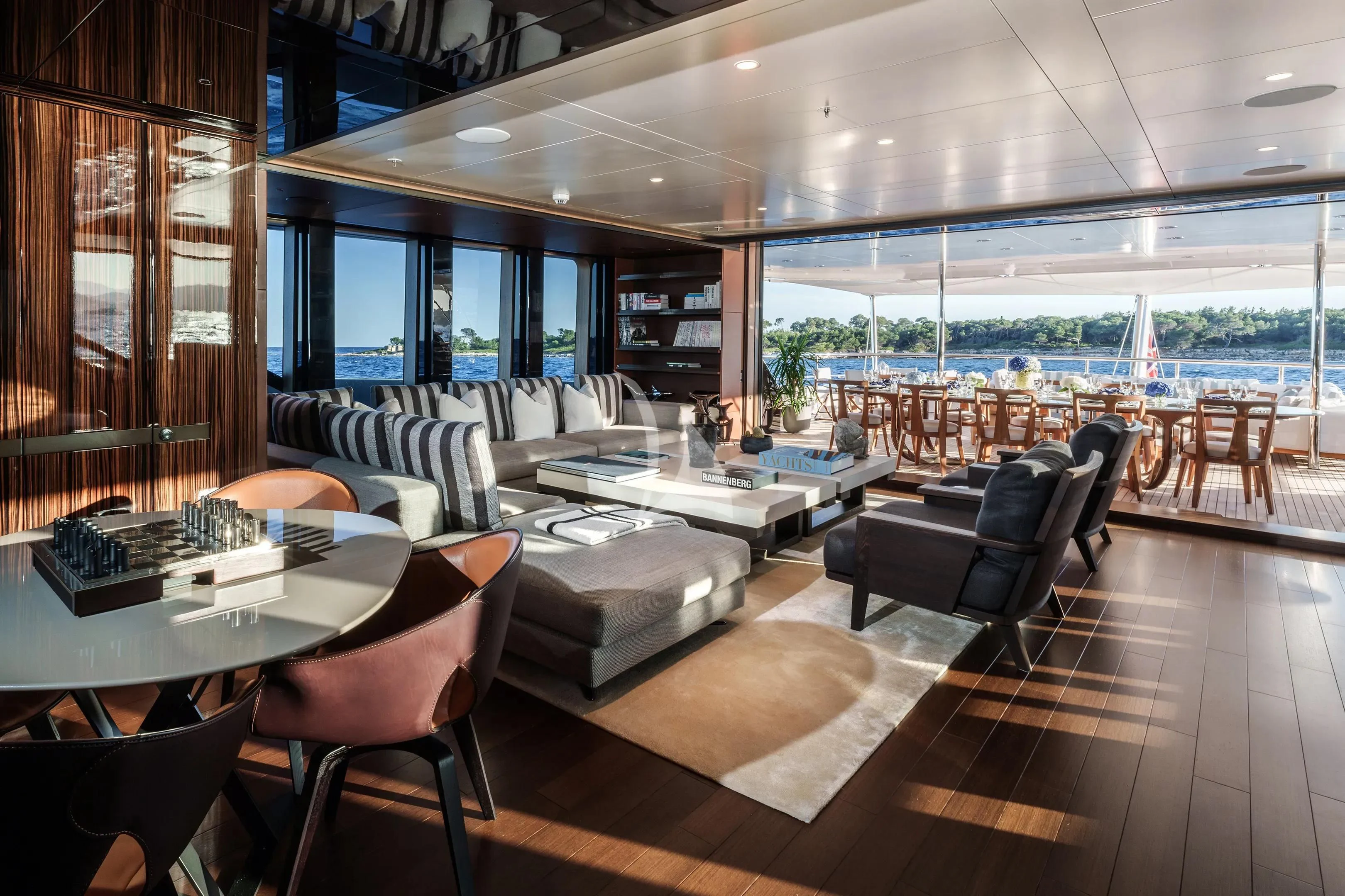 a room with a table chairs and a large window aboard HALO Yacht for Charter