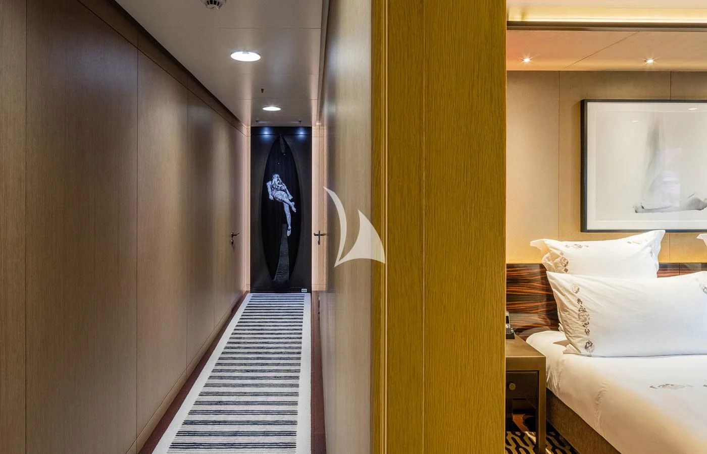 a room with a bed and a mirror aboard HALO Yacht for Charter