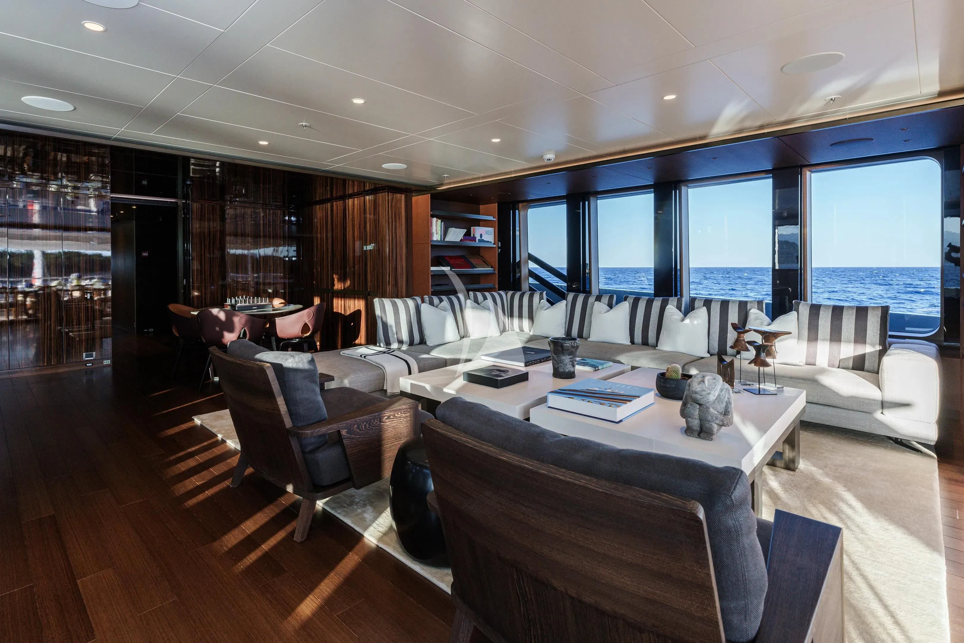 a large room with a table and chairs aboard HALO Yacht for Charter