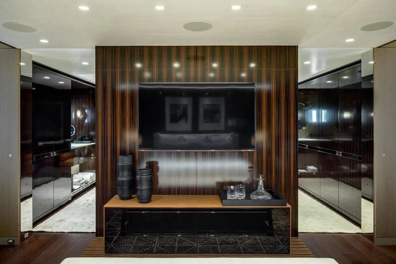 a room with a tv and a mirror aboard HALO Yacht for Charter