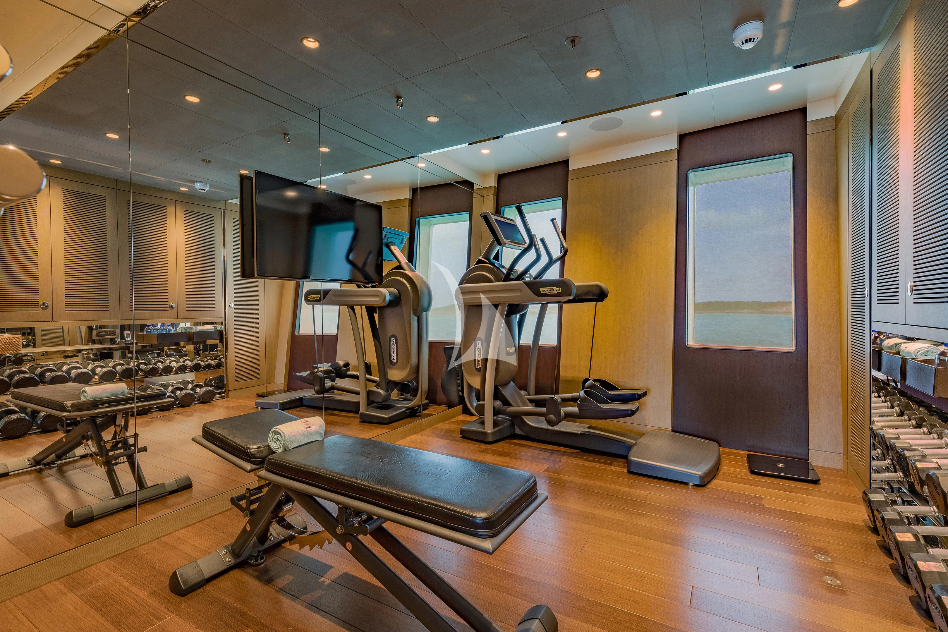 a gym with exercise equipment aboard HALO Yacht for Charter