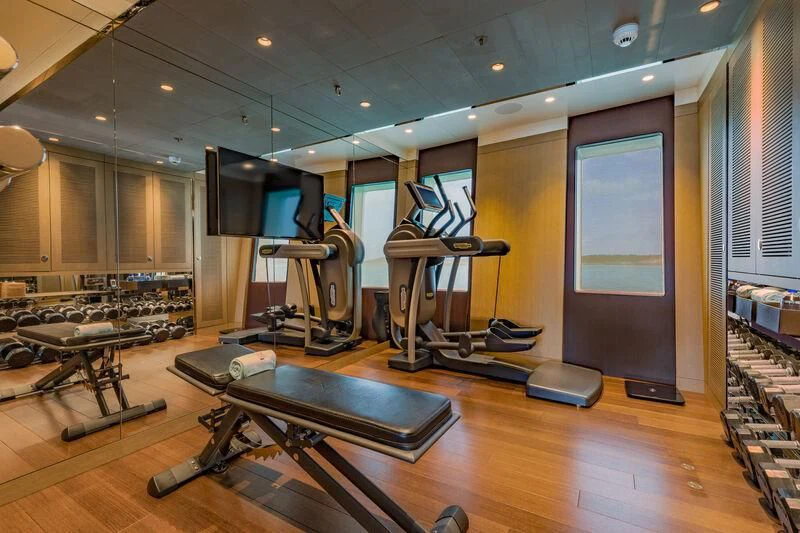 a gym with exercise equipment aboard HALO Yacht for Charter