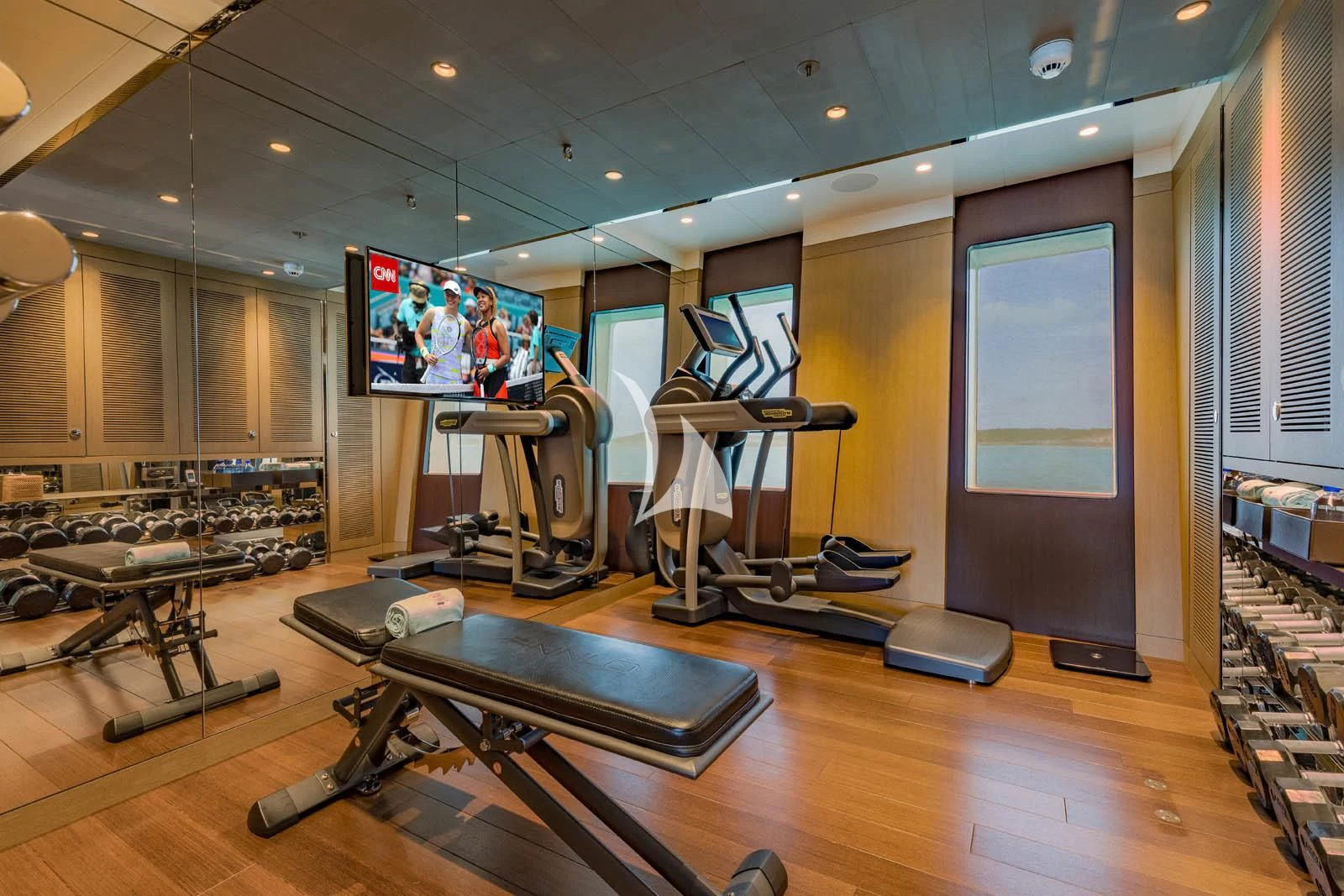 a gym with a large screen aboard HALO Yacht for Charter