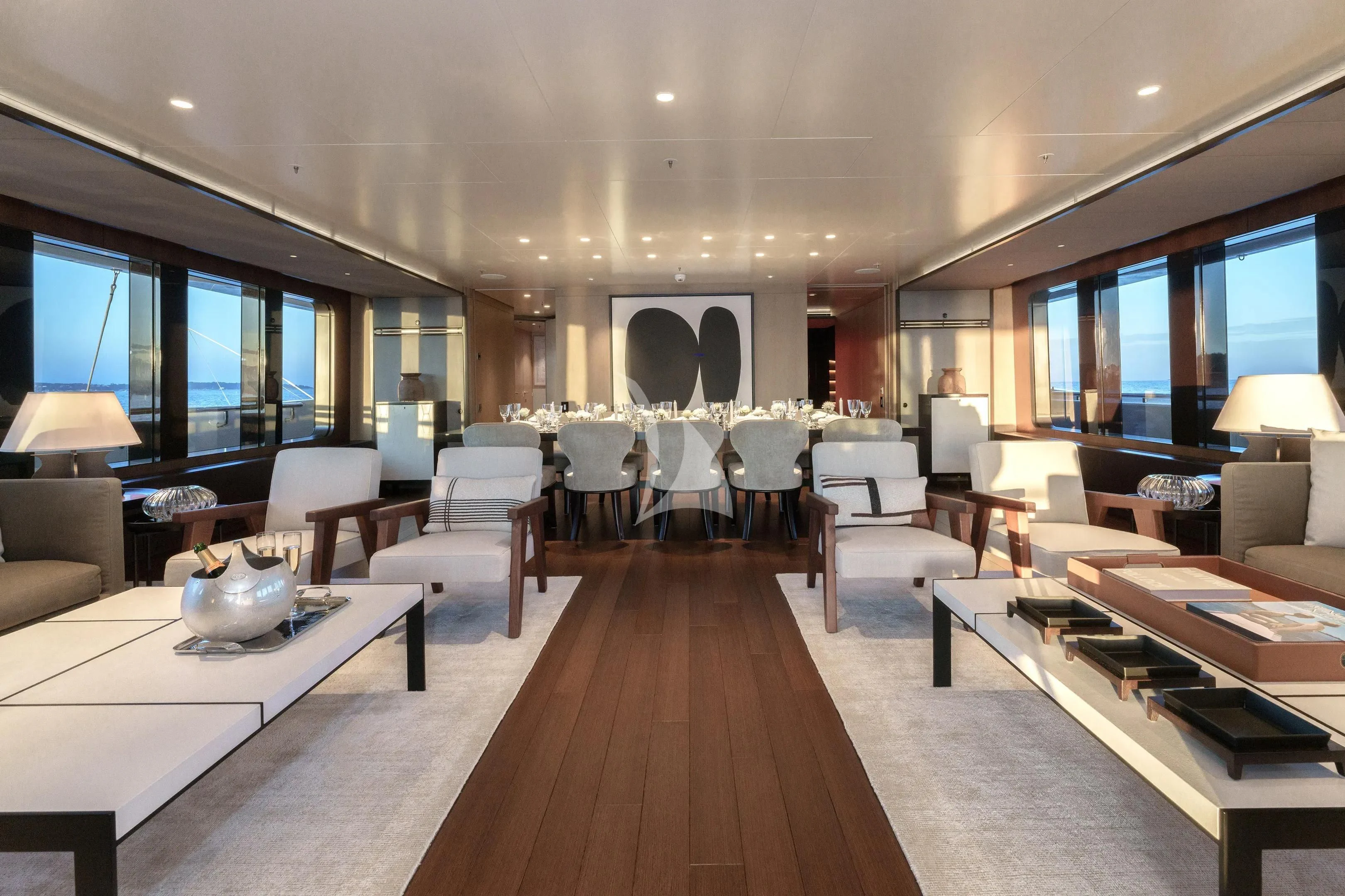 a large living room with a wood floor aboard HALO Yacht for Charter