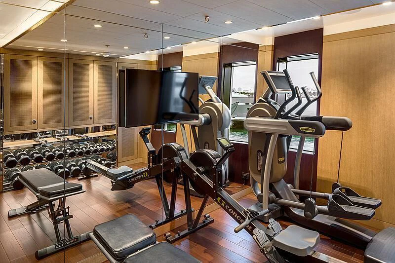 a gym with exercise equipment aboard HALO Yacht for Charter