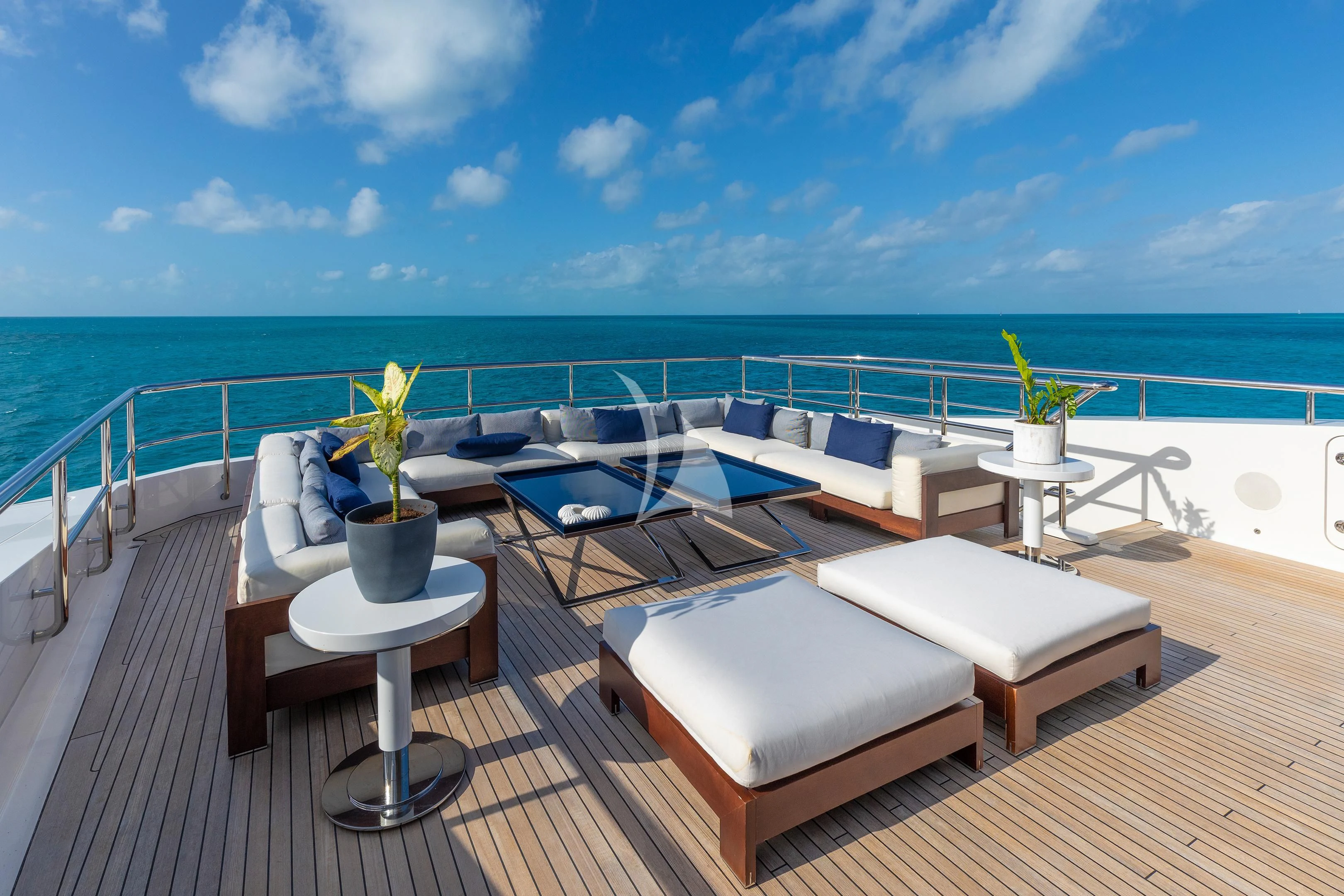 a deck with a view of the ocean and the ocean aboard HALO Yacht for Charter