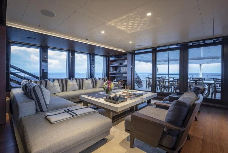 a living room with a large window aboard HALO Yacht for Charter