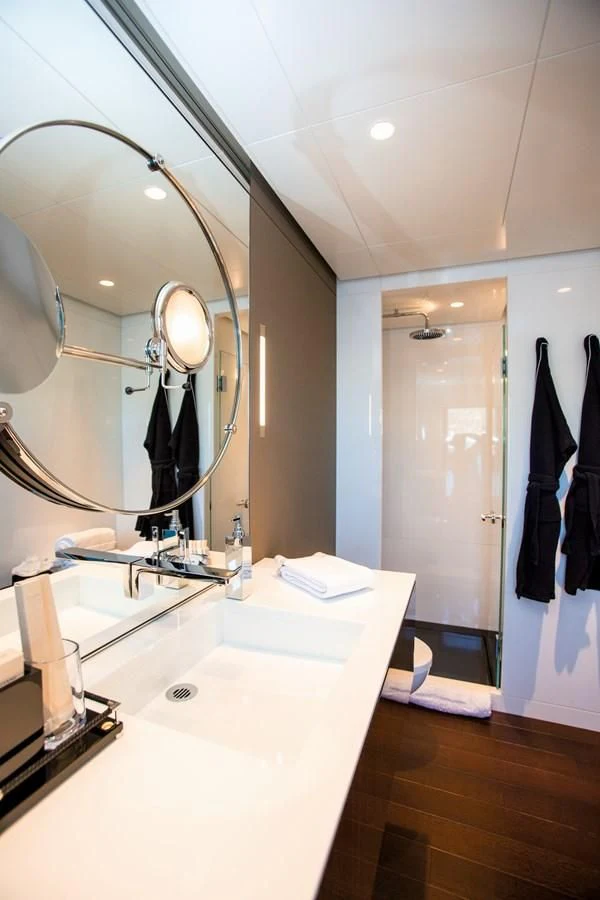 a bathroom with a large mirror aboard HALO Yacht for Charter
