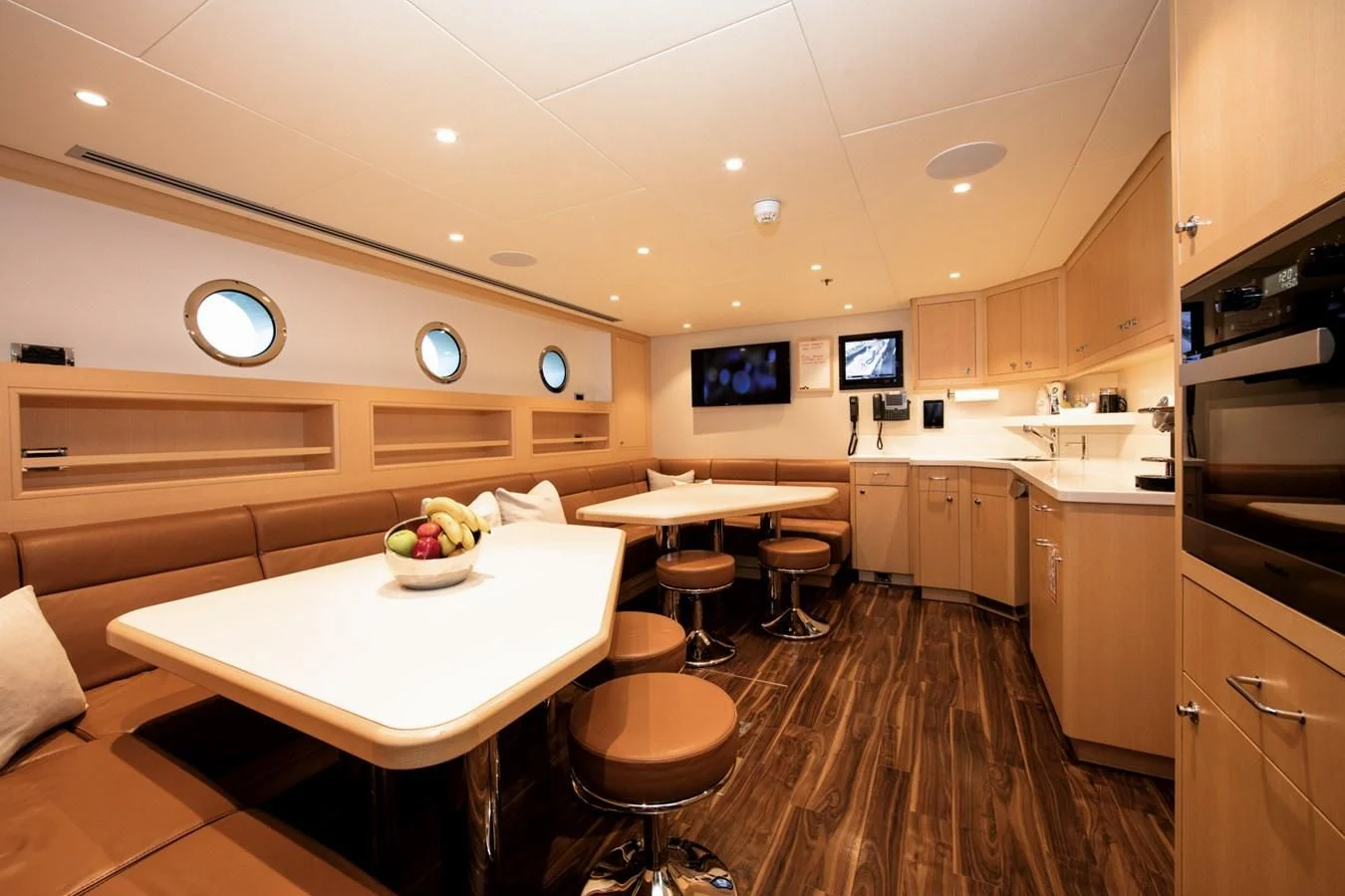 a kitchen with a table and chairs aboard HALO Yacht for Charter