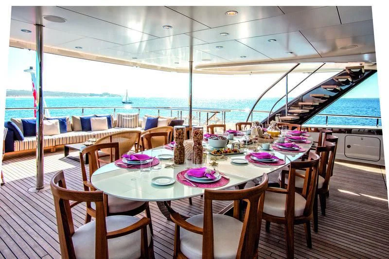 a table set for a meal on a deck aboard HALO Yacht for Charter