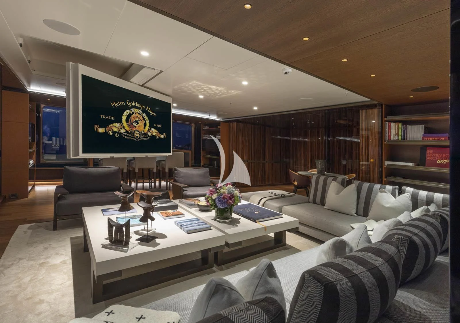 a living room with a large screen aboard HALO Yacht for Charter
