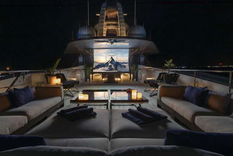 a living room with a large fish tank aboard HALO Yacht for Charter