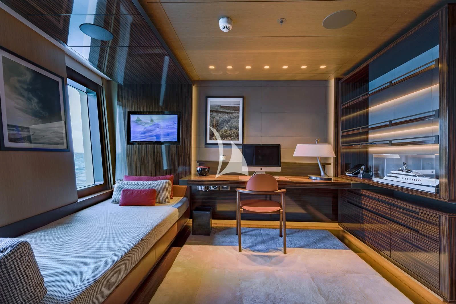 a room with a bed and a desk aboard HALO Yacht for Charter