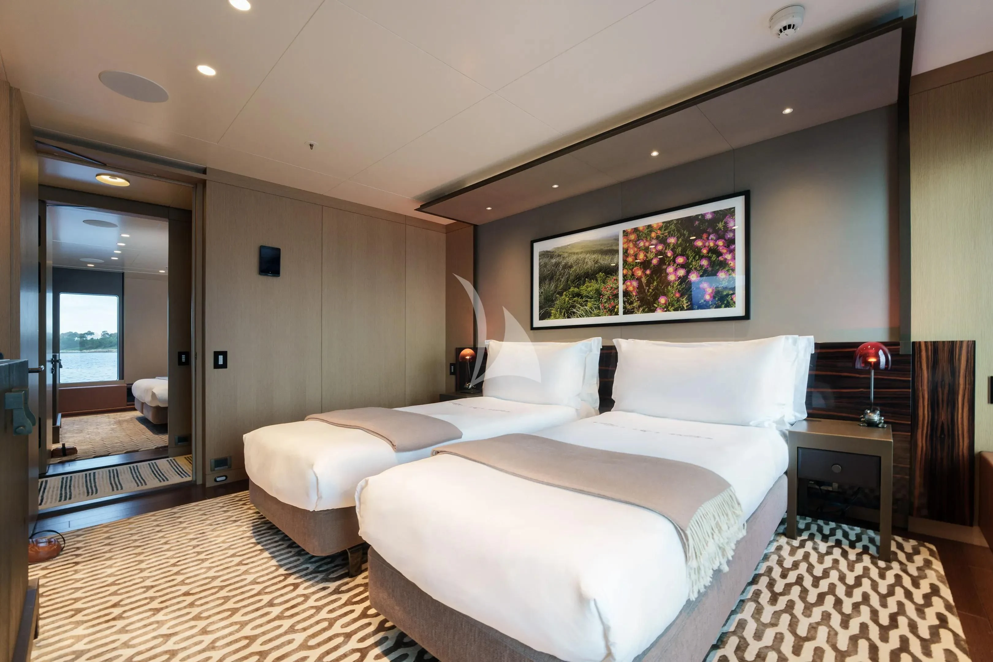 a room with a bed and a mirror aboard HALO Yacht for Charter