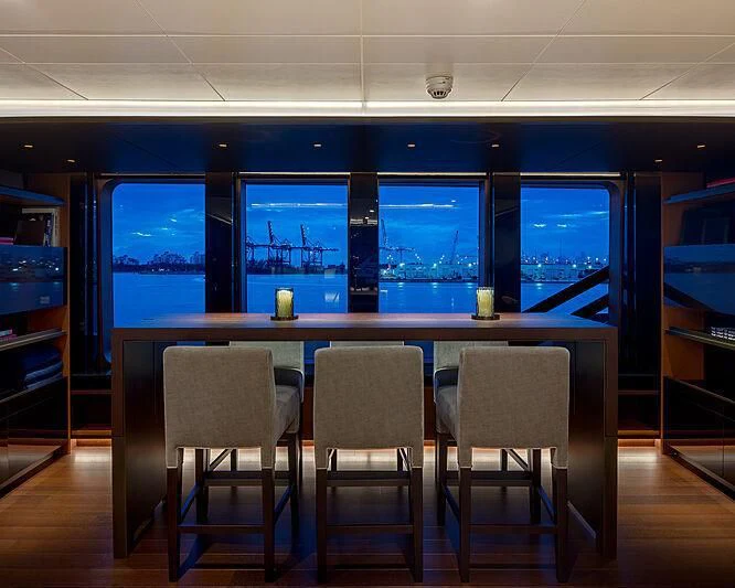 a room with a table and chairs aboard HALO Yacht for Charter
