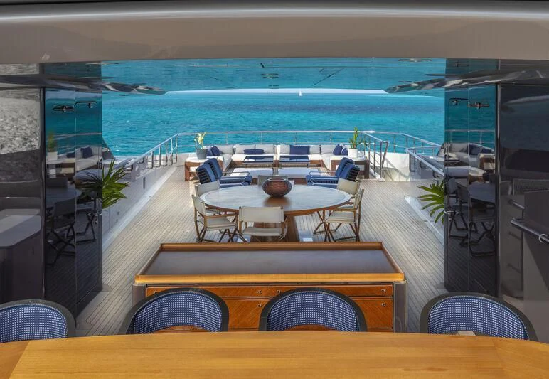 a room with tables and chairs aboard HALO Yacht for Charter