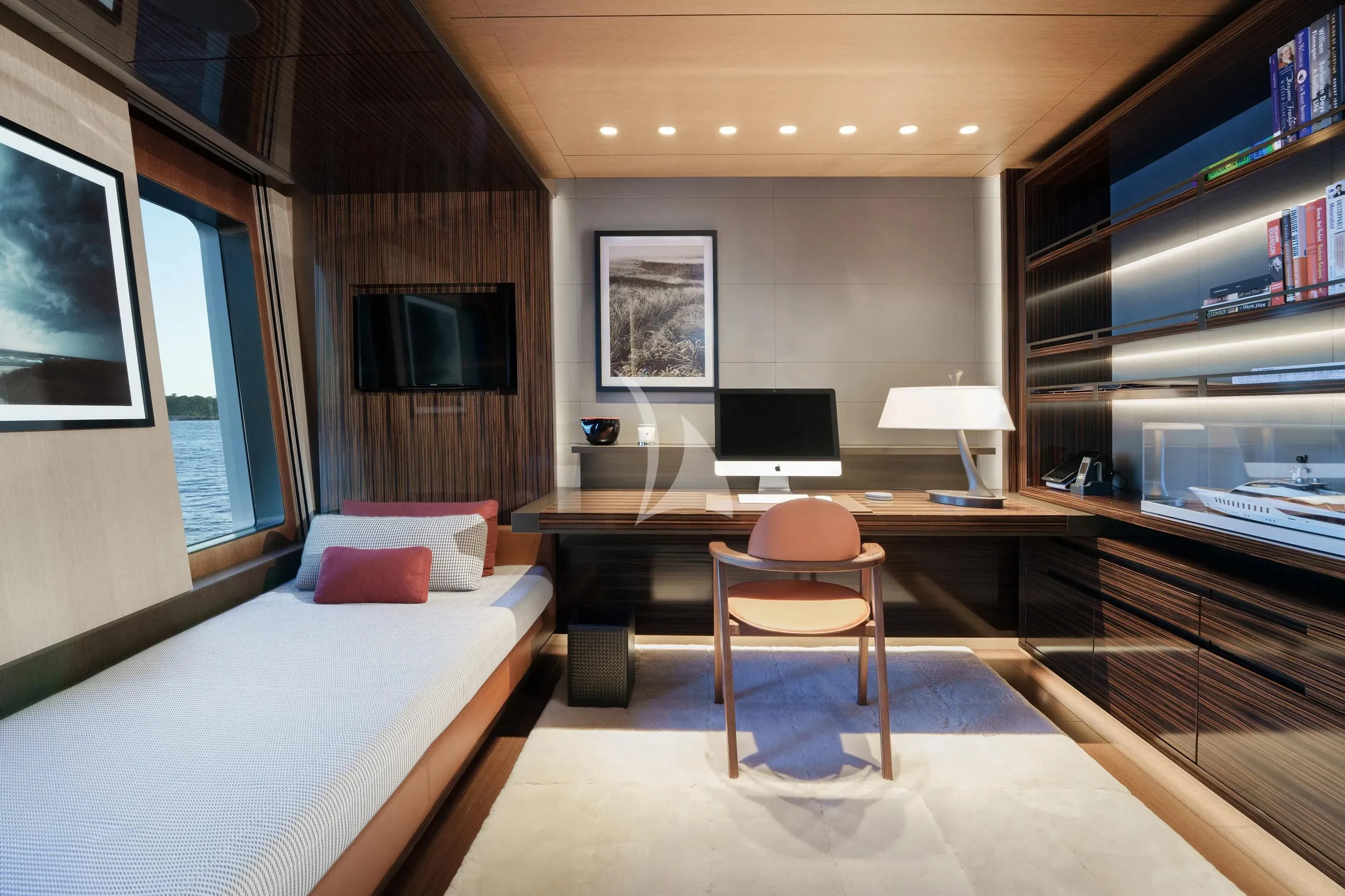 a room with a bed and a desk aboard HALO Yacht for Charter