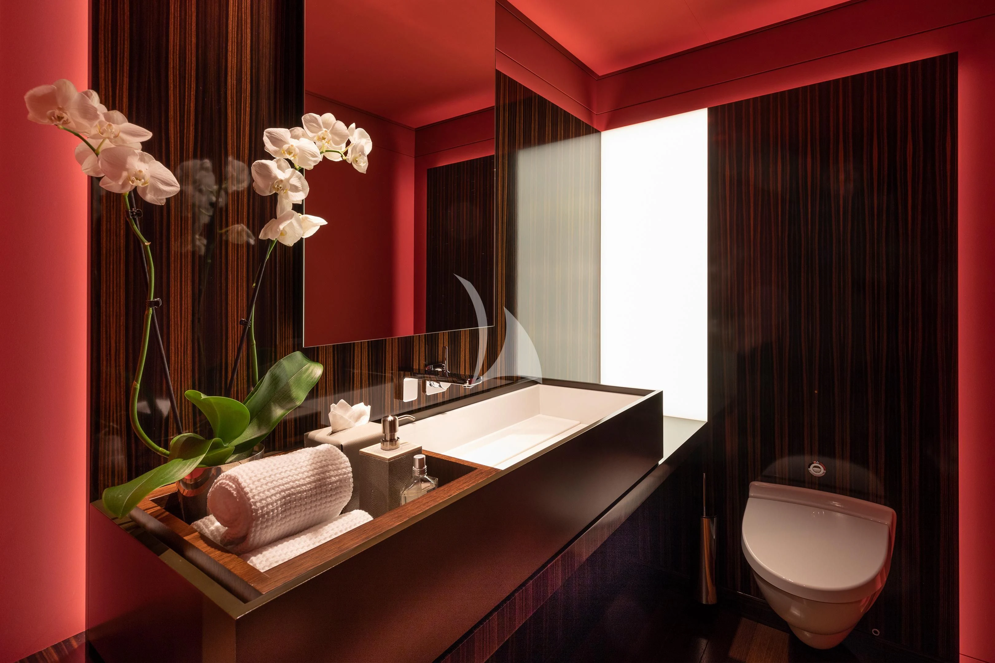 a bathroom with red walls aboard HALO Yacht for Charter
