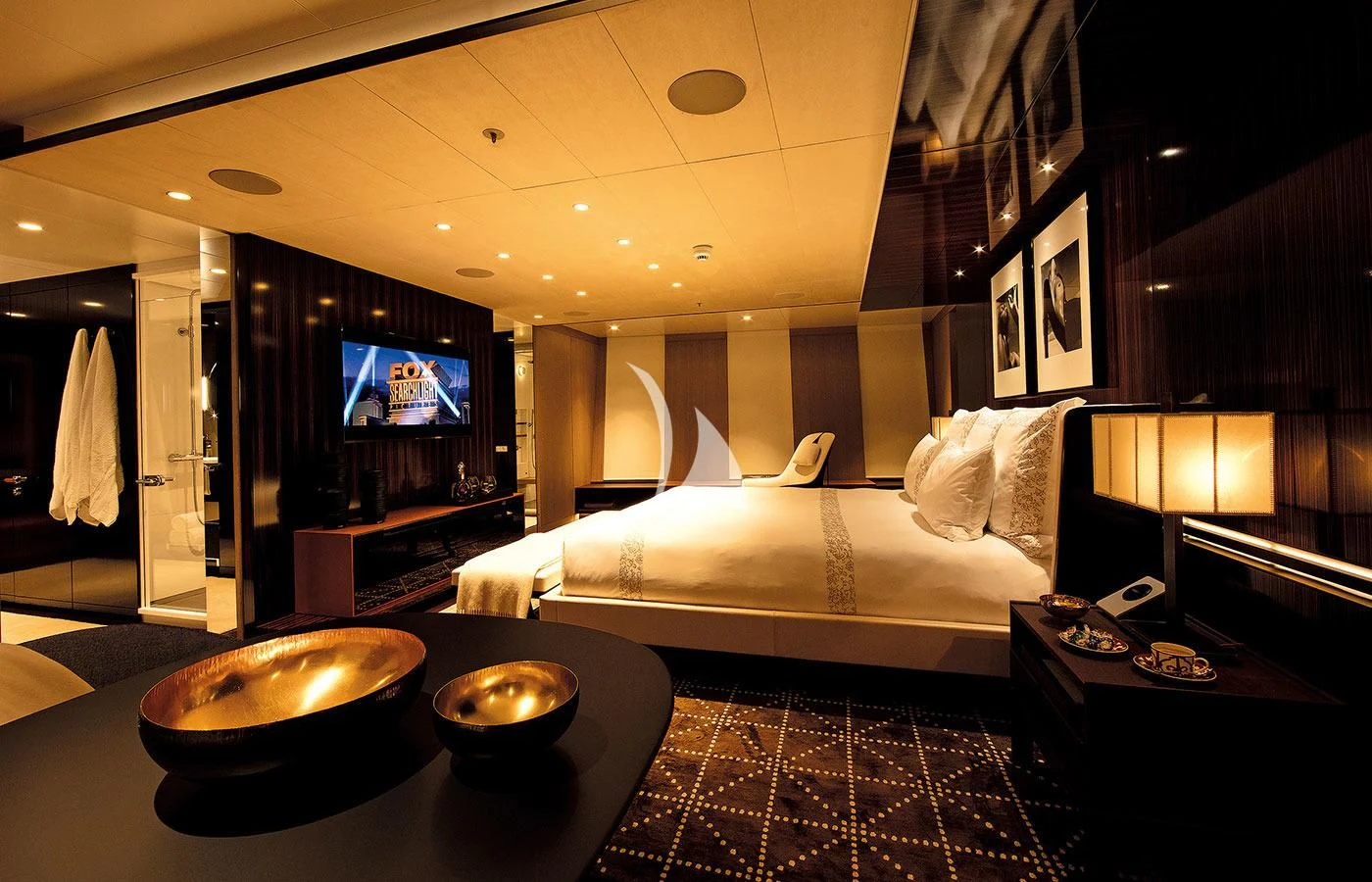 a hotel room with a bed and television aboard HALO Yacht for Charter