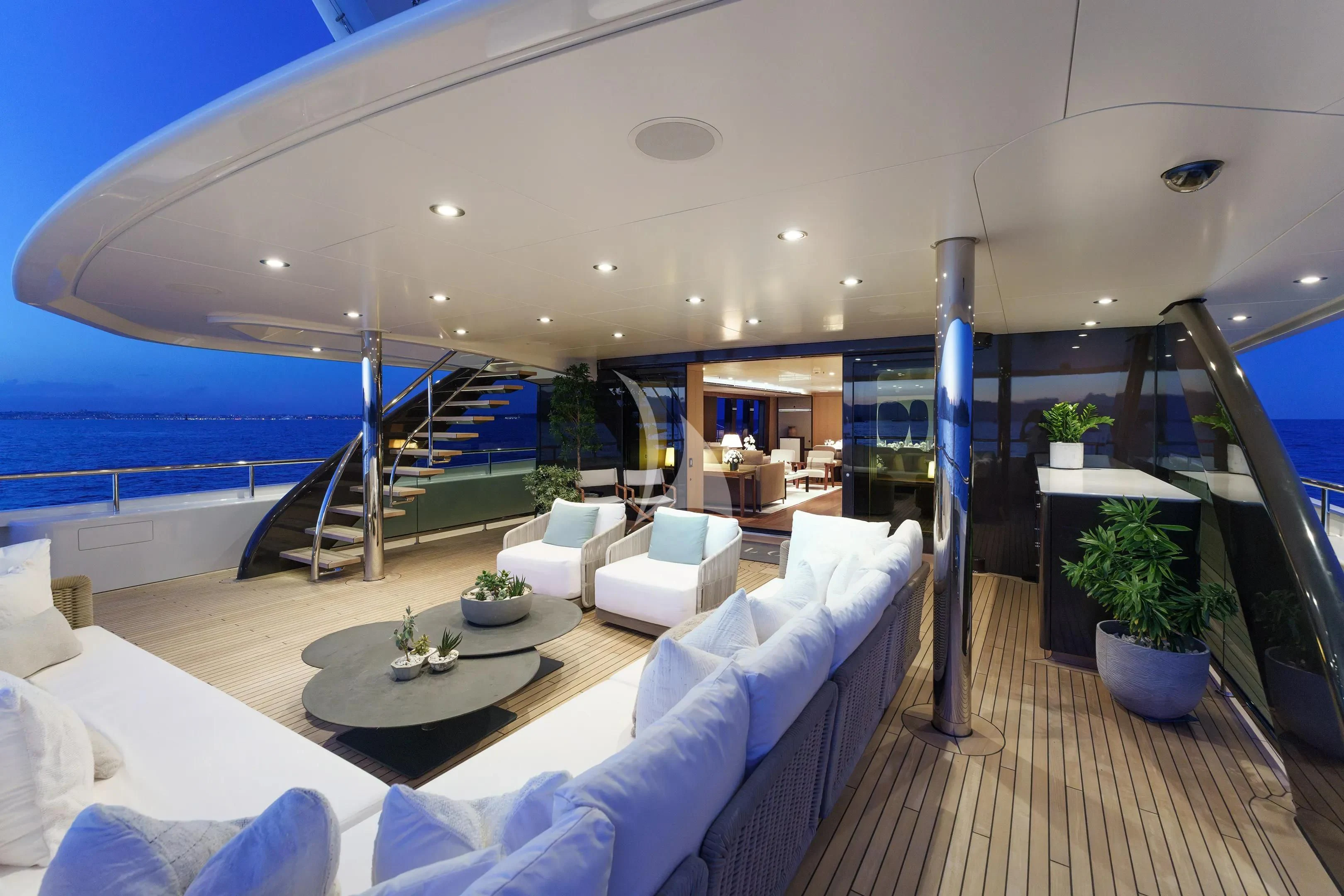a modern living room with a large balcony aboard HALO Yacht for Charter
