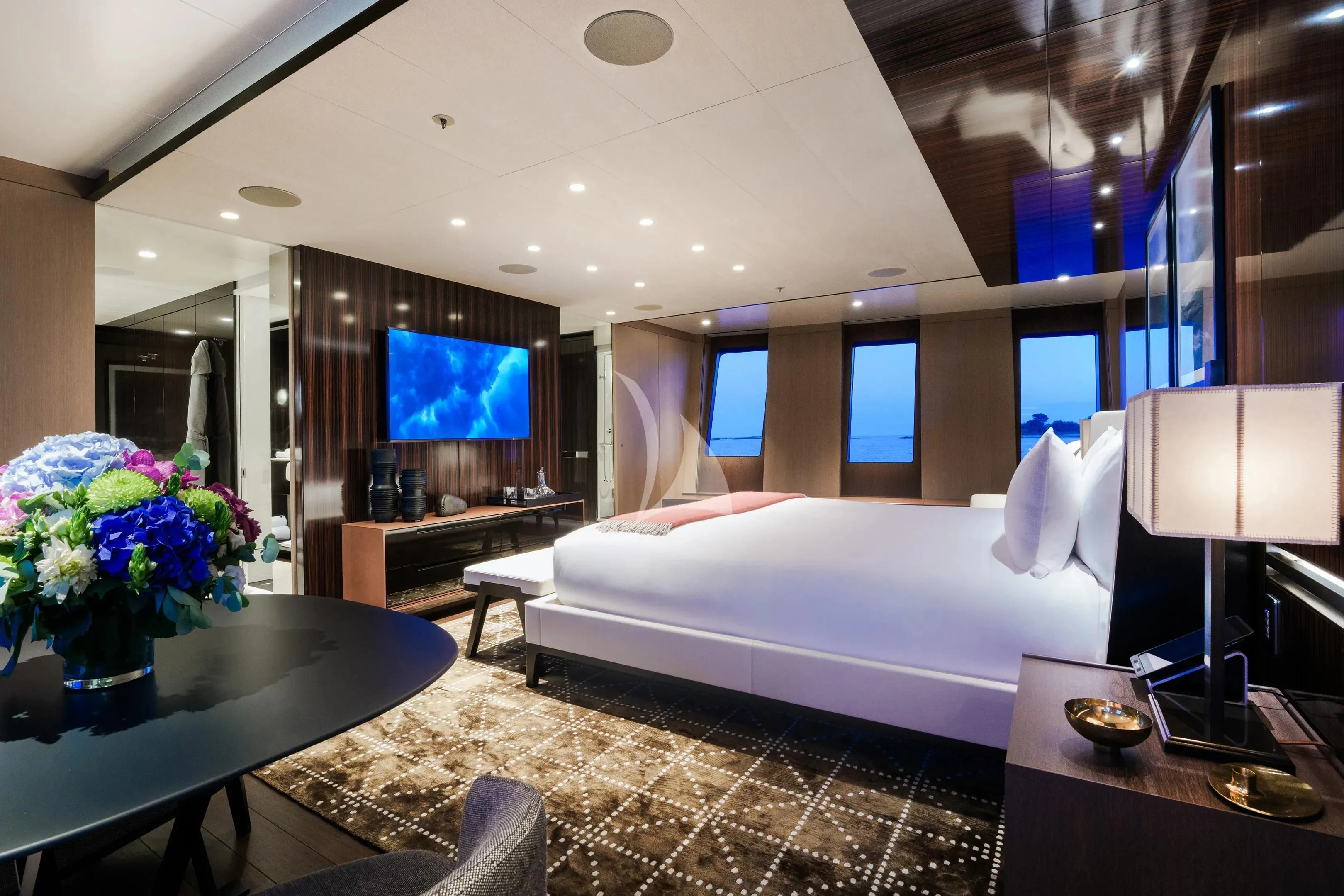 a hotel room with a bed and a tv aboard HALO Yacht for Charter
